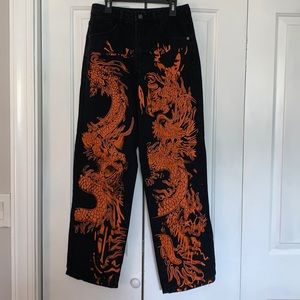 Orange and black dragon design jeans.